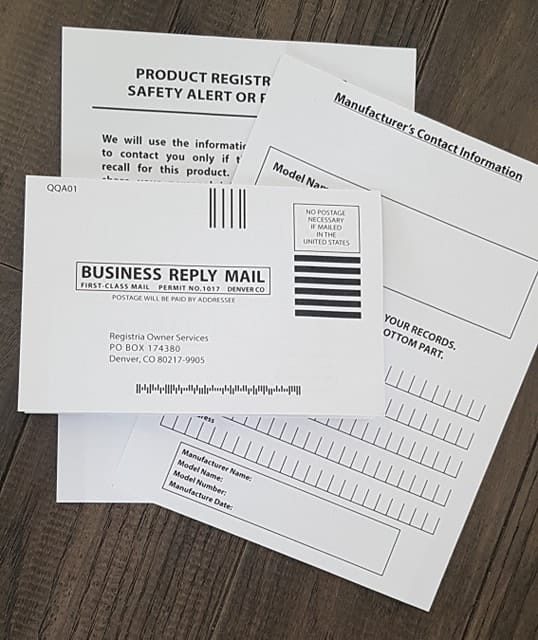 baby carrier product registration cards are stacked on a table