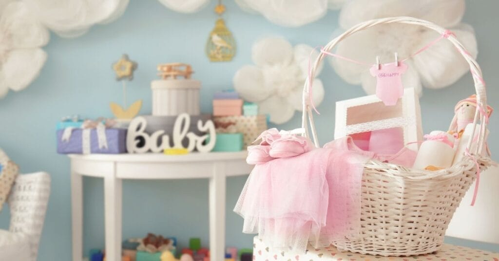 A basket of baby gifts in front of a nursery wall may contain white label baby carriers