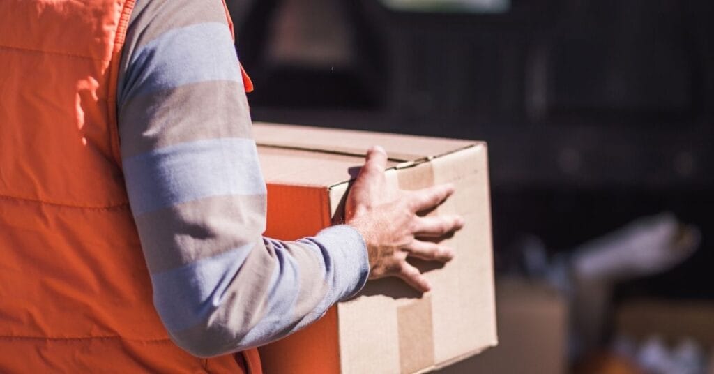 Importers must complete eFiling for slings and baby carriers intended for resale in the US. The person in the photo is carrying a small box, to indicate that even small-scale resellers must complete this requirement.